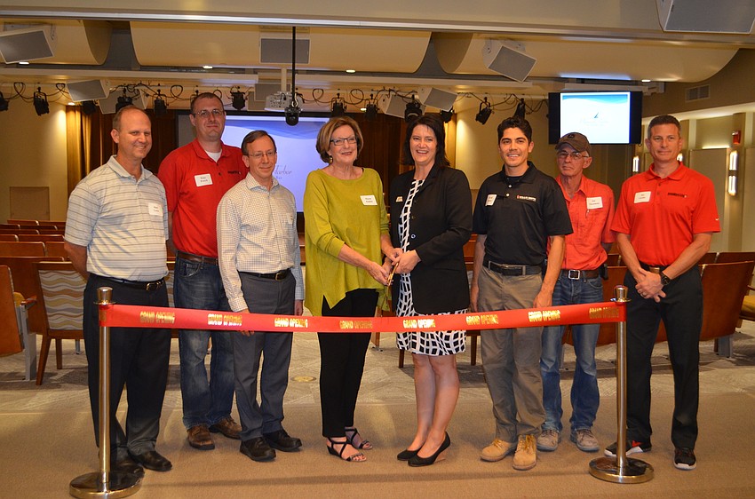 The planning and visioning committee for the Pilgrim Hall renovation stands at one of the entrances to the new theater.