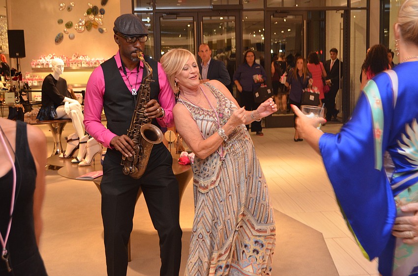 Beverly Marsh dances with musician Marton Boone at Key to the Cure on Thursday, Oct. 27, 2016 at Saks Fifth Avenue. Photo by Niki Kottmann