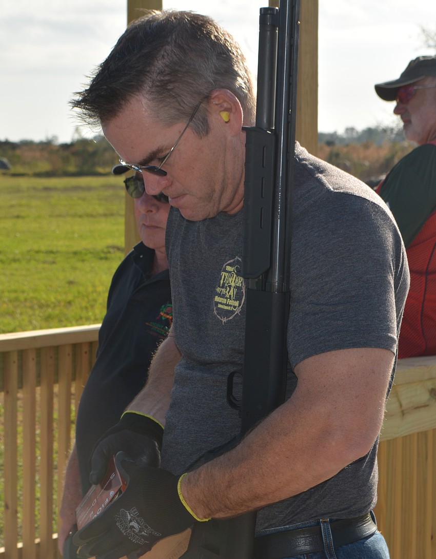 Scott Kessler, the general manager of Manatee River Harley-Davidson, gets his ammunition ready for the Sporting Clays Tournament.
