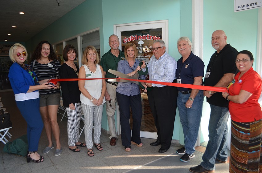 Longboat Key Chamber members, South Lake Design representatives and Cabinetree owners and employees cut the ribbon with Mayor Terry Gans.