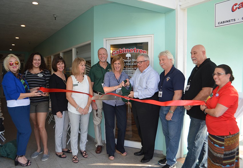 Longboat Key Chamber members, South Lake Design representatives and Cabinetree owners and employees cut the ribbon with Mayor Terry Gans.
