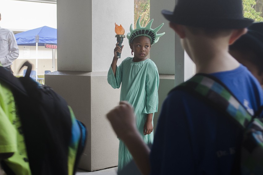 Myla Pitts, dressed as the Statue of Liberty, greeted students to Phillippi Shores Elementary School’s mock Ellis Island.