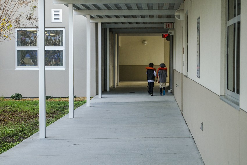 Ship captains Anderson Siegert and Henry Clausen walked back to the classrooms to get the next load of students to take to Ellis Island.