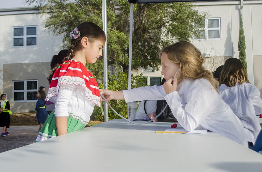 Lucy Lowther listens to Kaylee Chavez’s heart before completing her medical examination.