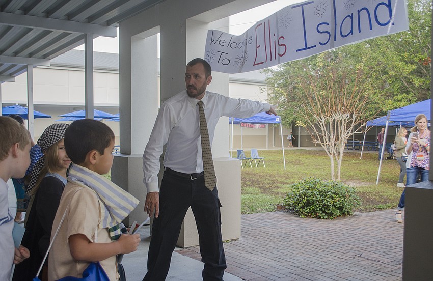 Second-grade teacher James Anderson welcomed students to Phillippi Shores Elementary School’s mock Ellis Island.