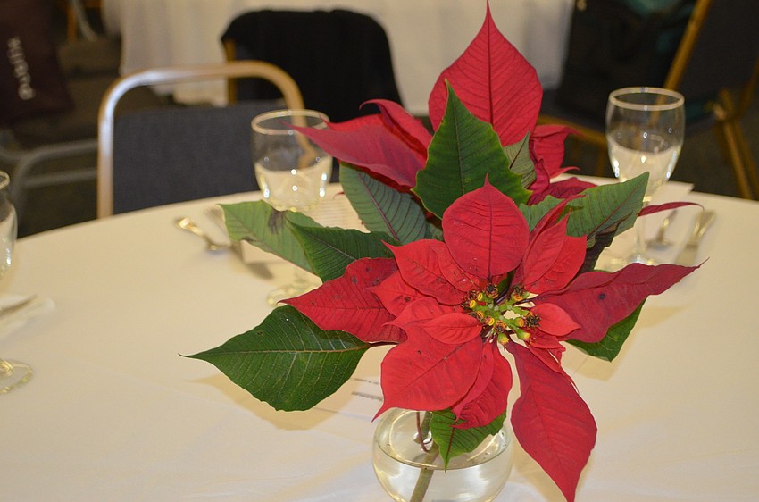 After the concert, guests enjoyed dinner in the parish hall. Poinsettias adorned each table in the hall.