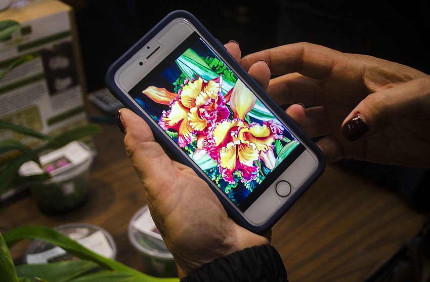 Kaiden shows some of her previous paintings.