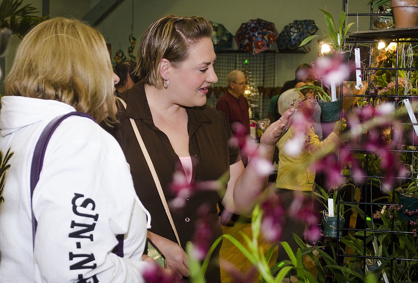 Nicole and Lori Sullivan admire some of the orchids for sale.