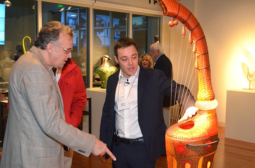 Marco Salvadore explains the process of creating one of the Salvadore glass pieces, “Tiraboson” by Davide Salvadore, to attendees.