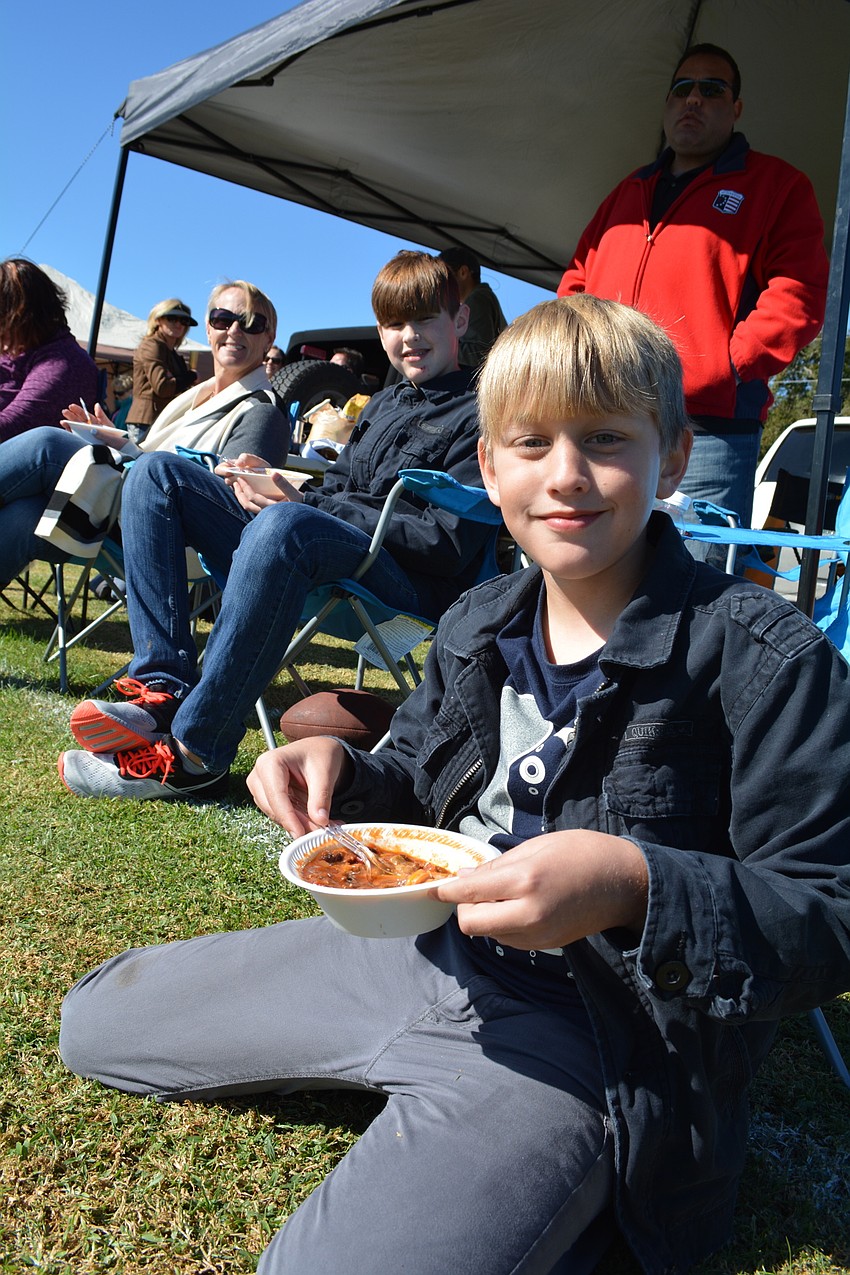 Will Ales, a student at Mills Elementary, feasts on chili with his family.
