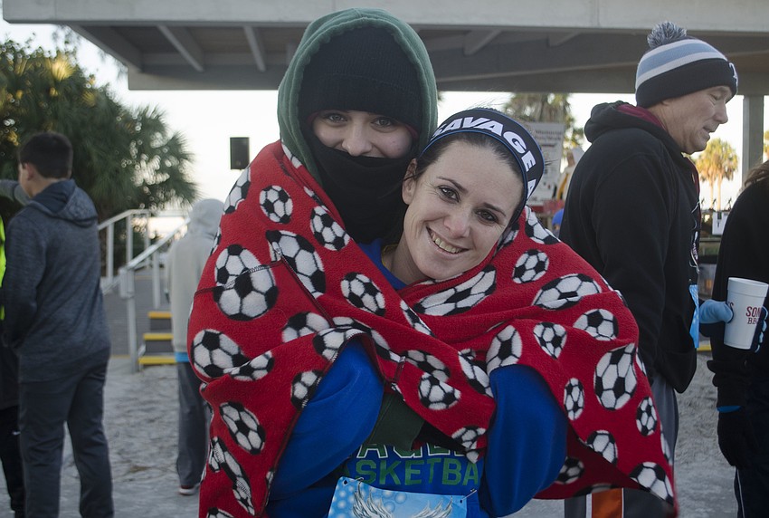 Caiti Ward wraps Krystal Young in a blanket before the race.
