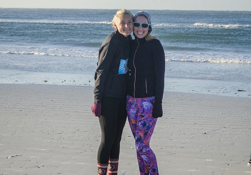 Sage Lyons and Phoebe Colvin Oehmig pose near the start line of the Andrew Monroe 5K.