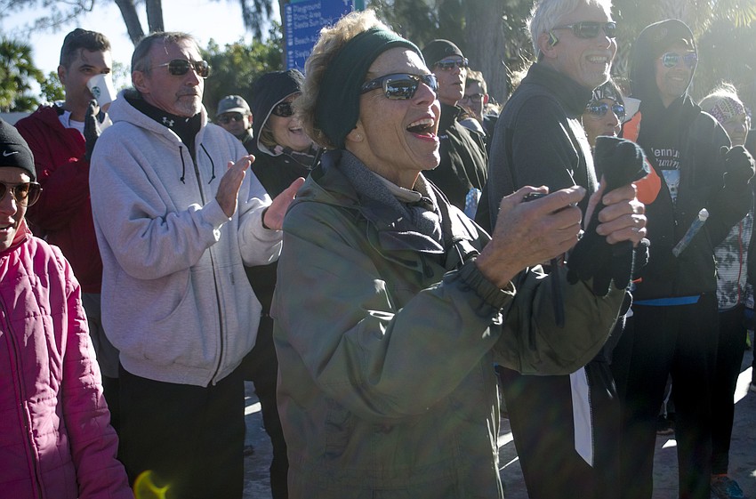 Dee Nelson joins fellow runners in singing “Happy Birthday” to Stacey Monroe. Monroe’s birthday was Jan. 8, the day of the race.