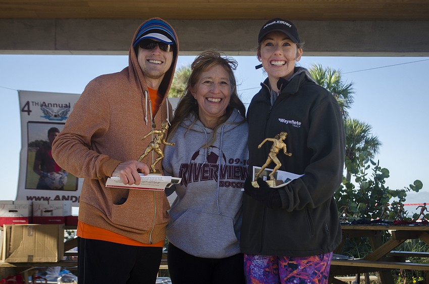 Taylor Henninge and Phoebe Colvin Oehmig pose with Stacey Monroe after being given their trophies.