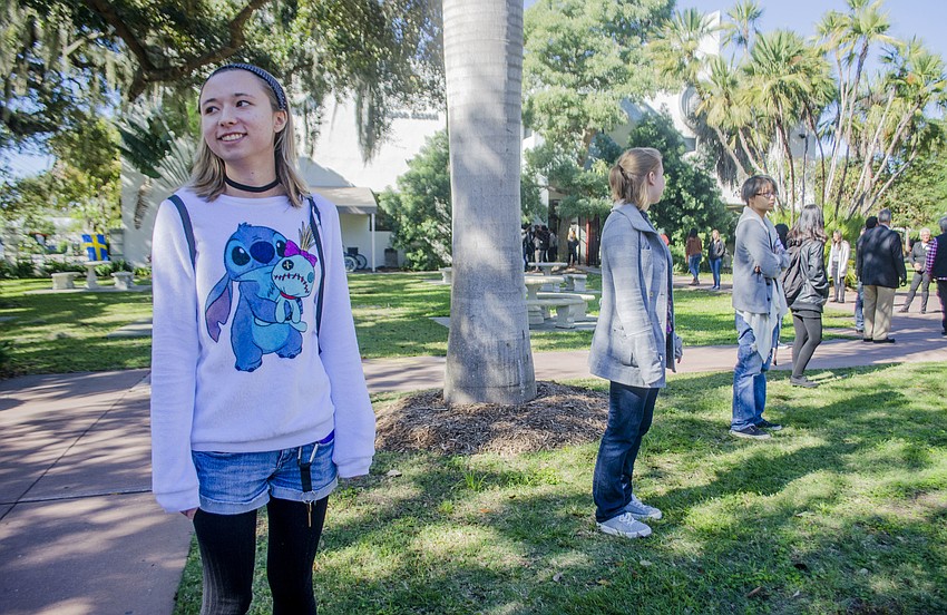 Carley Butella waits in line before the ceremonial passing of the books from Kimbrough Library to Ringling'    s new Alfred R. Goldstein Library.
