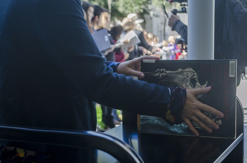 Director of Library Services Kristina Keough places books on shelves at  the Alfred R. Goldstein Library.