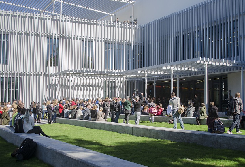 Students and faculty listen to Ringling College of Art and Design President Larry Thompson as he addresses the audience in front of the  Alfred R. Goldstein Library.