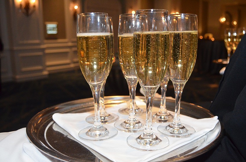 Servers with trays full of champagne awaited attendees Jan. 8 at The Ritz-Carlton, Sarasota.