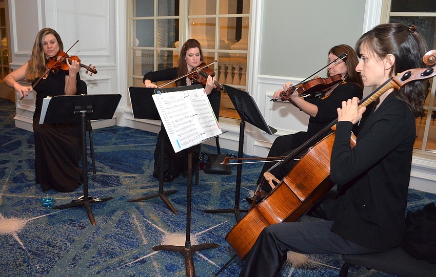 Sarasota Orchestra members Margot Zarzyka, Shawna Trost, Jeanie Phelan and Nadine Trudell perform during the champagne reception.