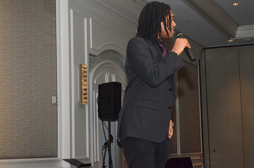 Baritone Jeremiah Smith performs for attendees during dinner.