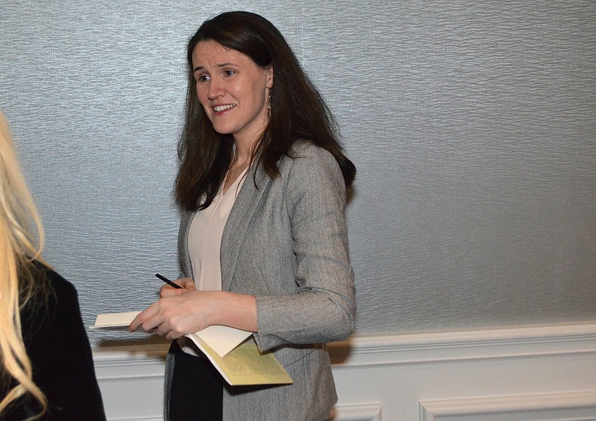 Liz Murray autographs a copy of her book.