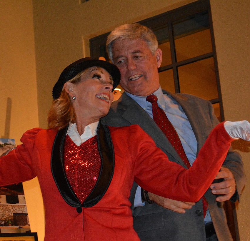 Dancer Nancy Creighton ties to coax Players Director of Development Dennis McSweeney into a little audience participation.