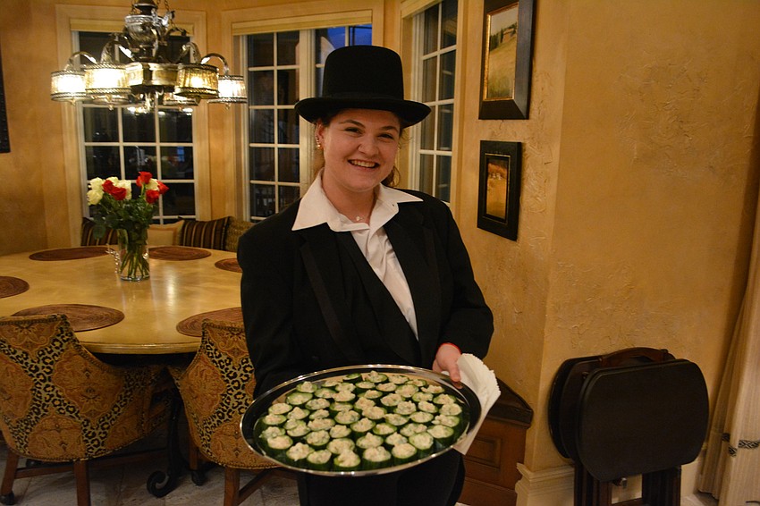 Erica Brown, the daughter of The Player Board of Trustees Chairman Michael Brown, helps as a server.