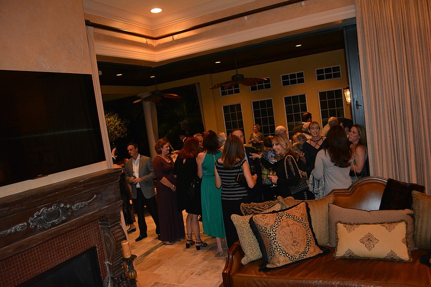 Guests pack a room at Lou and Ann Marie Marinaccio'  s Concession home.