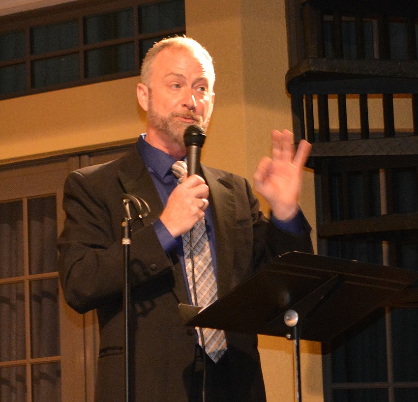 Players Artistic Director Jeffery Kin conducts the silent auction.
