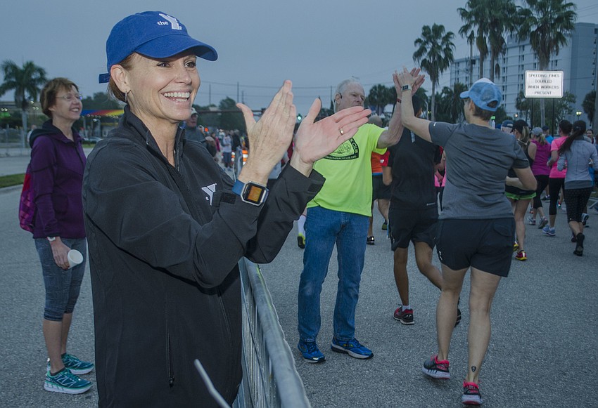 Race Director Rhonda Kapusta cheers runners on at the starting line of the 14th annual Ringling Bridge Run.
