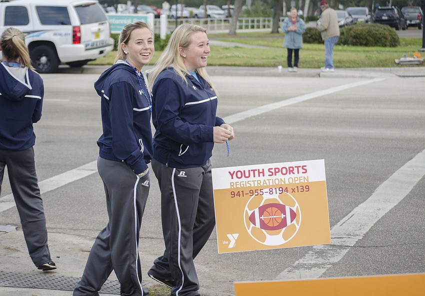 Jessica Harney and Hannah Gross cheer on runners at the final turn of the 14th annual Ringling Bridge Run.