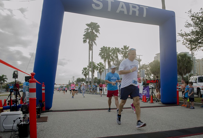 Runners cross the finish line of the 14th annual Ringling Bridge Run.
