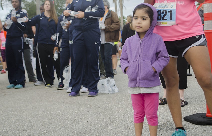 Jasmine Acosta waits for her cousin the cross the finish line of the 14th annual Ringling Bridge Run.