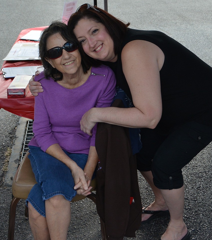 Rosalie Wakefield and Sarah Wakefield enjoy a break from selling fundraising bricks for the new lodge during the open house.