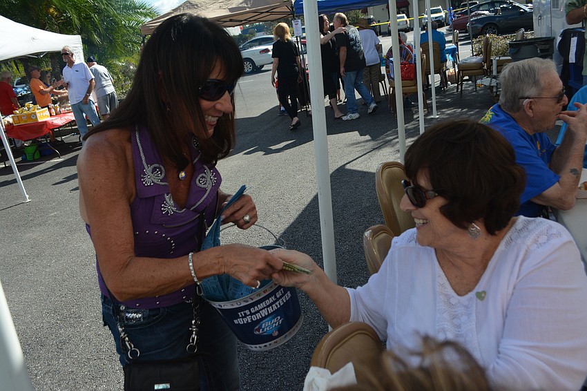 Roe Hyer sells raffle tickets to Teri Dangel at the open house.
