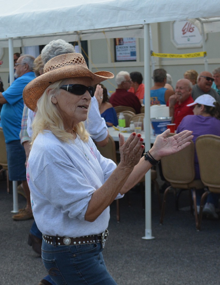 Roxanne Winstead, the head of the County Rockers line dancing team, enjoys  a song during the Elks open house.