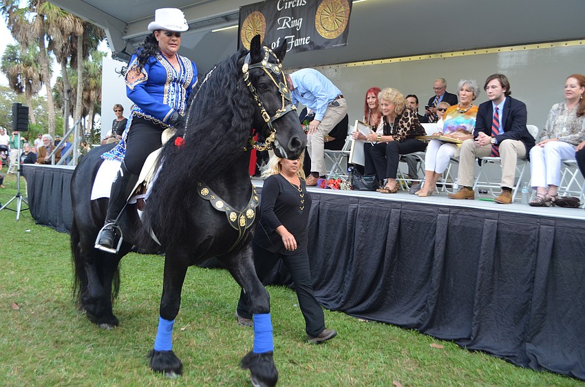 Desiree Hermann and Hedzer walk through the crowd during the Circus Ring of Fame induction.