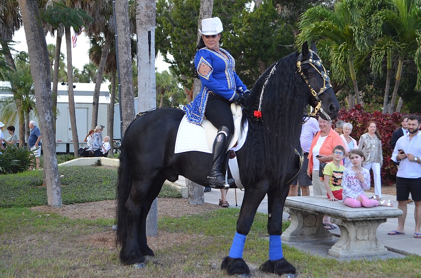 Desiree Hermann and Hedzer wait for the plaque to be unveiled.
