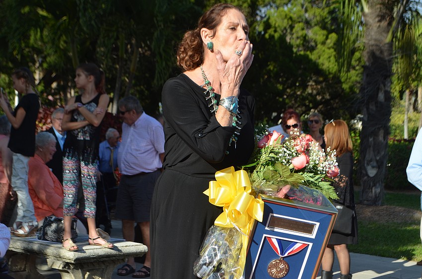 Dora Foster, better known in the circus world as Rogana, blows kisses to her friends and family members before unveiling her plaque.