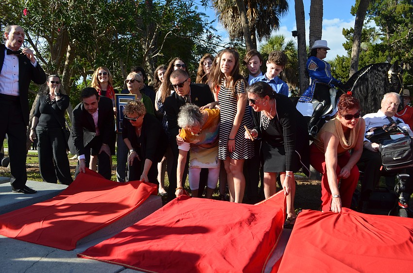 Family, friends and inductees unveil the new plaques.