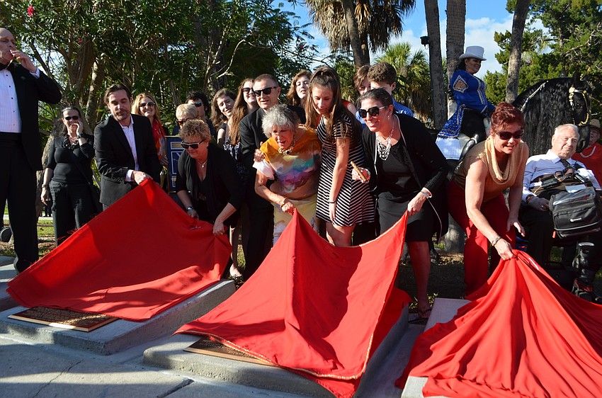 Family, friends and inductees unveil the new plaques. John Esola constructs the bases and mounts the bronze wheels and plaques for each inductee.