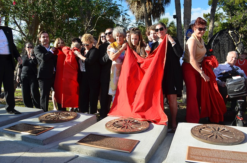 Family, friends and inductees unveil the new plaques. John Esola constructs the bases and mounts the bronze wheels and plaques for each inductee.