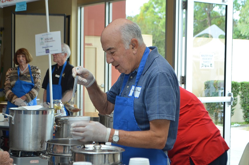 Saville Pelmont ladles soup into a bowl during the 9th annual Jewish Food Festival.