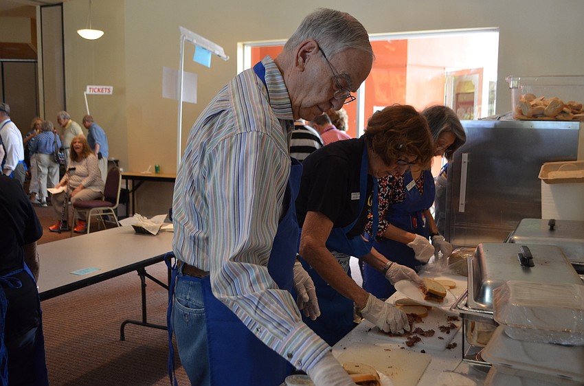 Irwin Livon, Jan Joseph and Toniet Wolfson make pastrami sandwiches during the Jewish Food Festival.