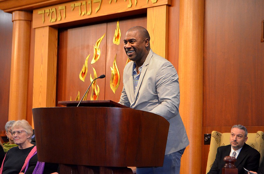 Neil Phillips, principal and co-founder of Visible Men Academy, speaks to the crowd.