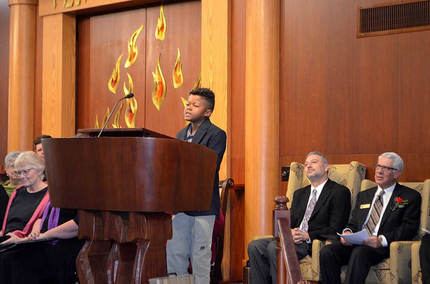 Frankie Clark, 10, reads a poem about the Rev. Dr. Martin Luther King Jr.