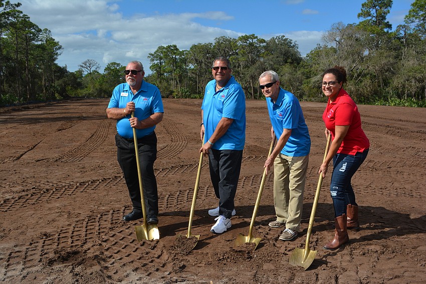 Jerry Ditty, Darrin Simone, Randy Volkart and Kathy Hogue, members of  the building committee, use their gold shovels at the groundbreaking ceremony.