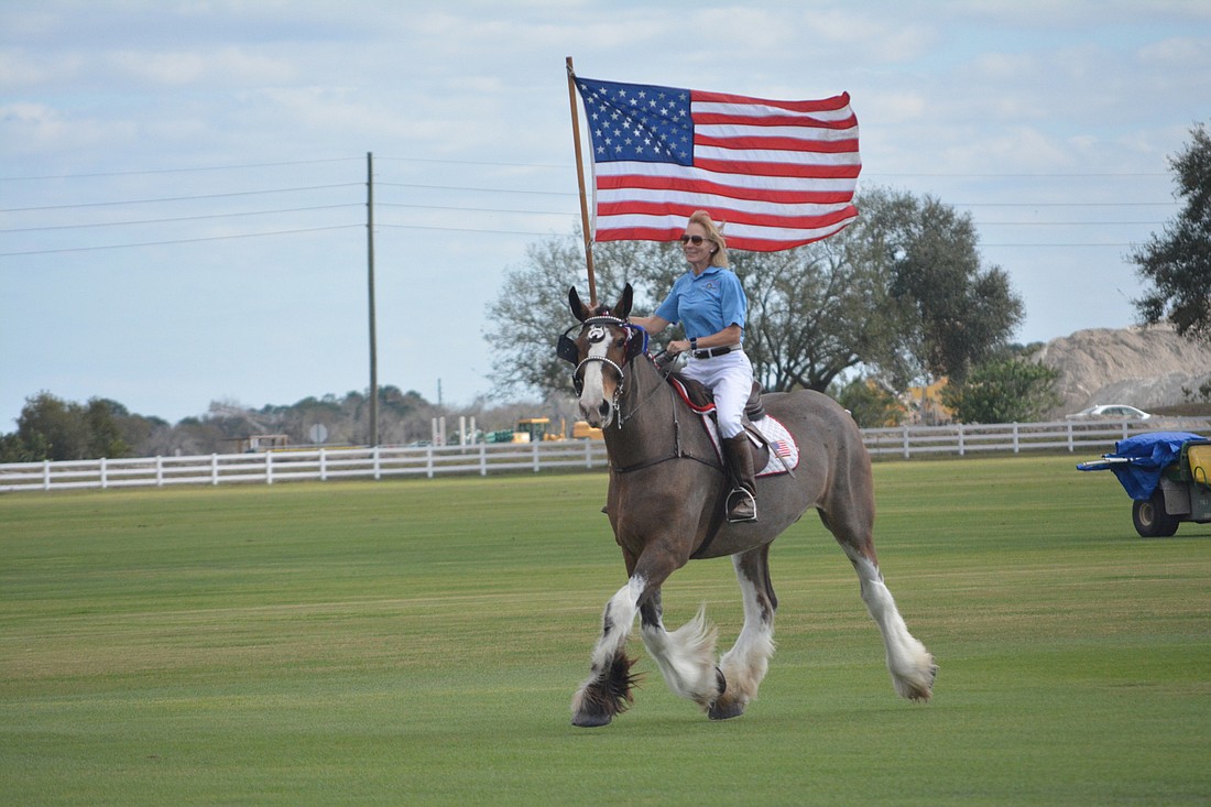 Barb Alexander rides the American flag out before the match.