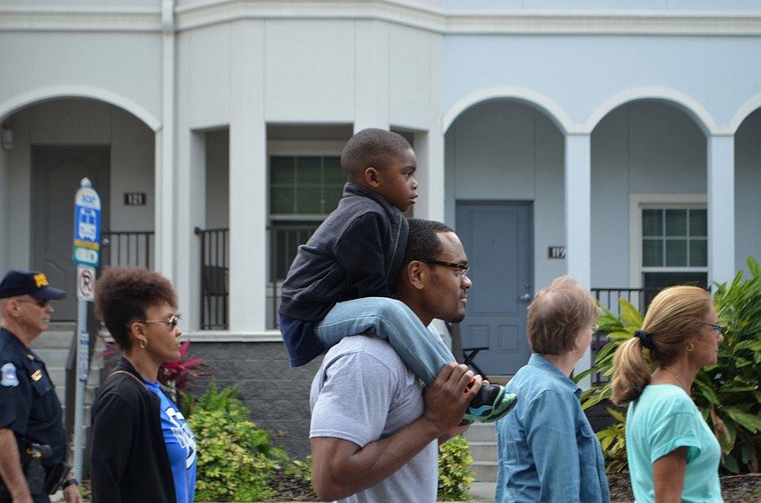 Mason Peterson, 4, gets a lift from Donald Bell.