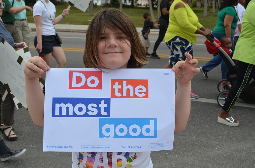 Emily Hulvey, 6, holds up a sign she carried during the walk.